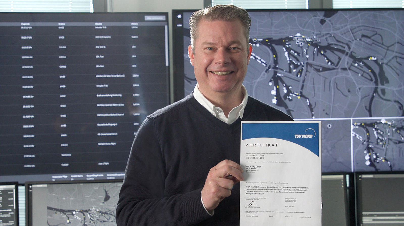 HHLA Sky representative shows TÜV Nord certificate