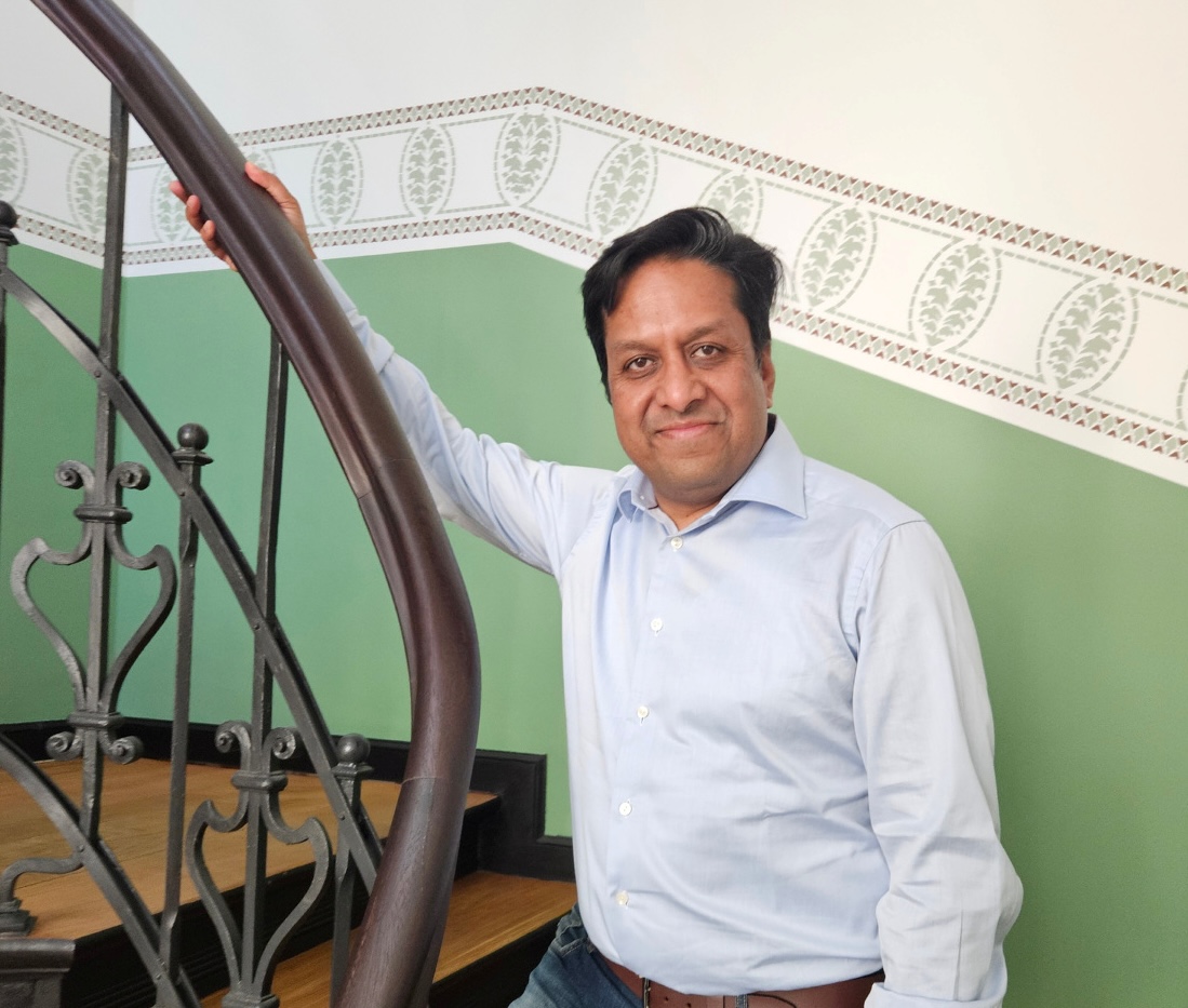 HHLA Sky Chief Revenue Officer Neeraj Bansal standing on stairs