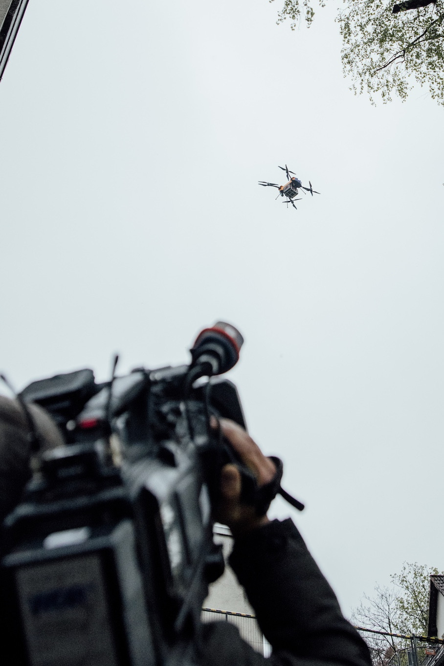 Camera team filming a flying drone