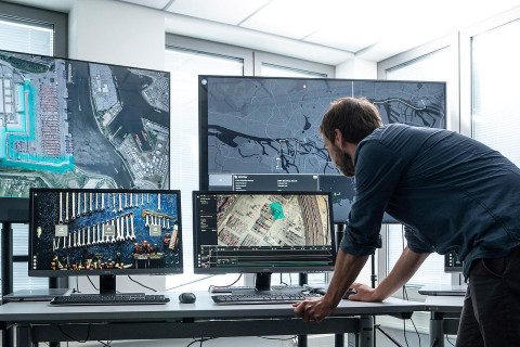 An operator at the HHLA Sky Integrated Control Center for simultaneous automated drone and mobile robot operations at large-scale