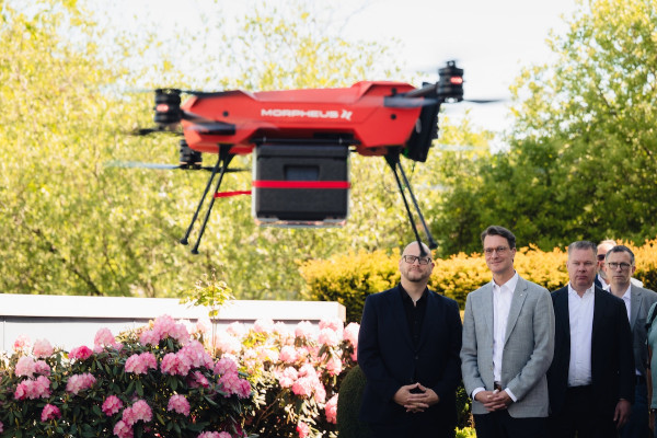 North Rhine-Westphalia's Minister President Hendrik Wüst follows the take-off of a X25 drone at Morpheus Logistik, Germany. Here with Morpheus Logistik CEO Norman Koerschulte and HHLA Sky Managing Director Matthias Gronstedt. An X25 drone takes off in the foreground.